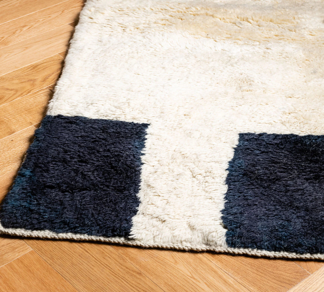 Modern Geometric Beni Mrirt rug with black and ivory blocks, Moroccan wool design.