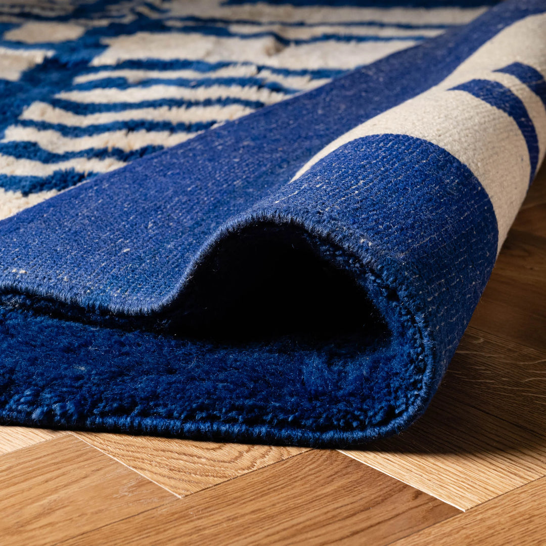 Close-up of a blue Modern Moroccan Rug with an abstract geometric Berber design, showcasing its wool texture and intricate patterns.