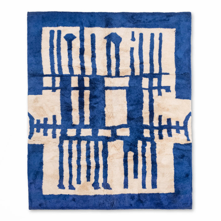 Abstract geometric Moroccan rug in blue and cream, handwoven Berber design from Morocco, perfect for contemporary spaces.