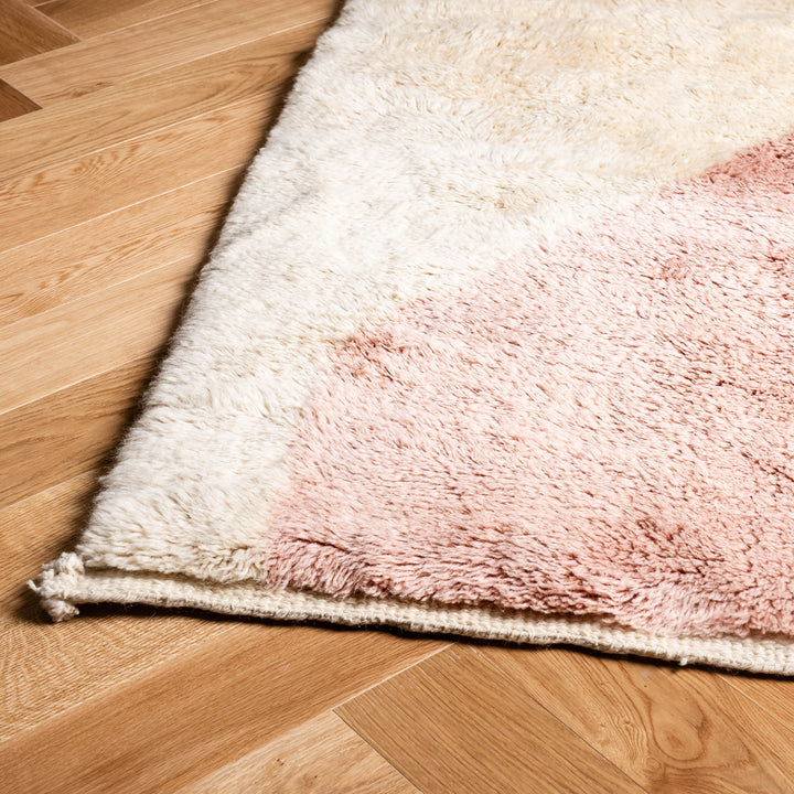Modern pink abstract Beni Mrirt Moroccan wool rug on wood floor