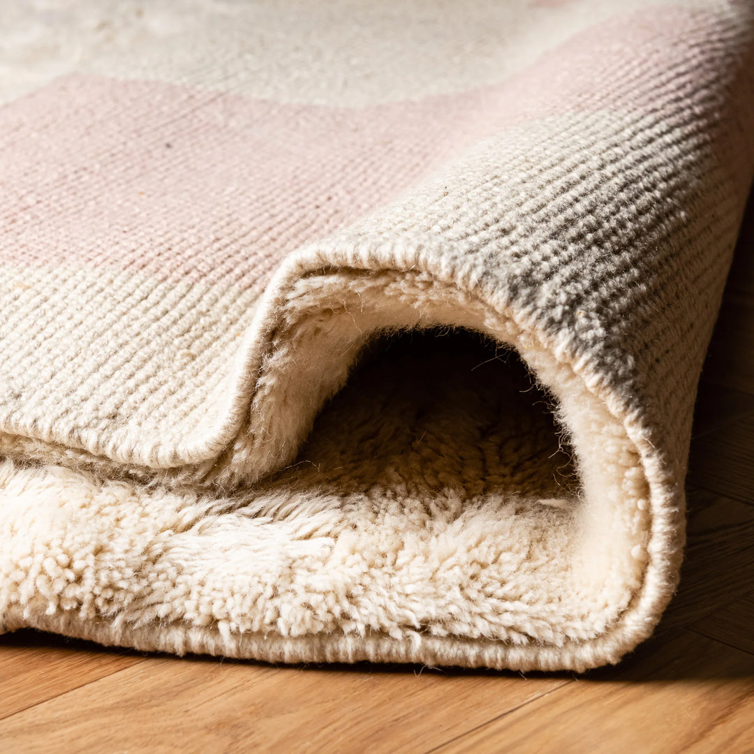 Close-up of Modern Pink Abstract Beni Mrirt Moroccan Wool Rug, showcasing hand-knotted ivory texture and abstract pink design.