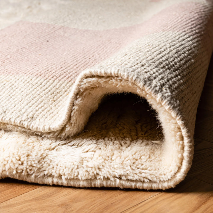 Close-up of Modern Pink Abstract Beni Mrirt Moroccan Wool Rug, showcasing hand-knotted ivory texture and abstract pink design.