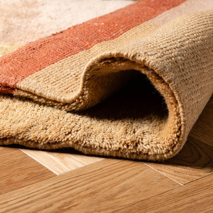 Close-up of a handwoven Moroccan runner rug with rich colors on wooden flooring.