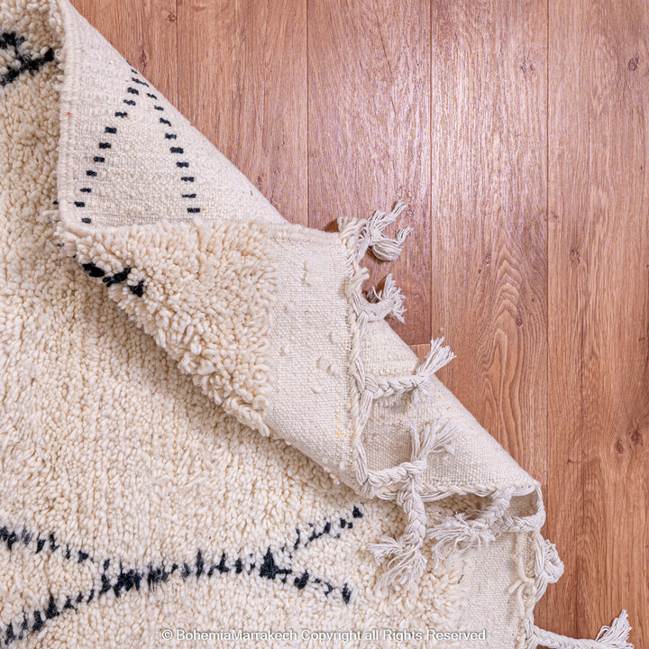 Handmade Beni Ourain Moroccan rug with black diamond pattern on ivory wool