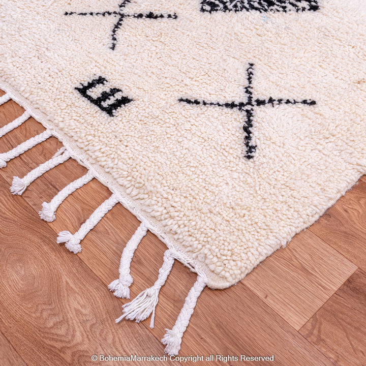 Hand-knotted Beni Ourain Moroccan rug with black tribal diamond patterns on white wool background