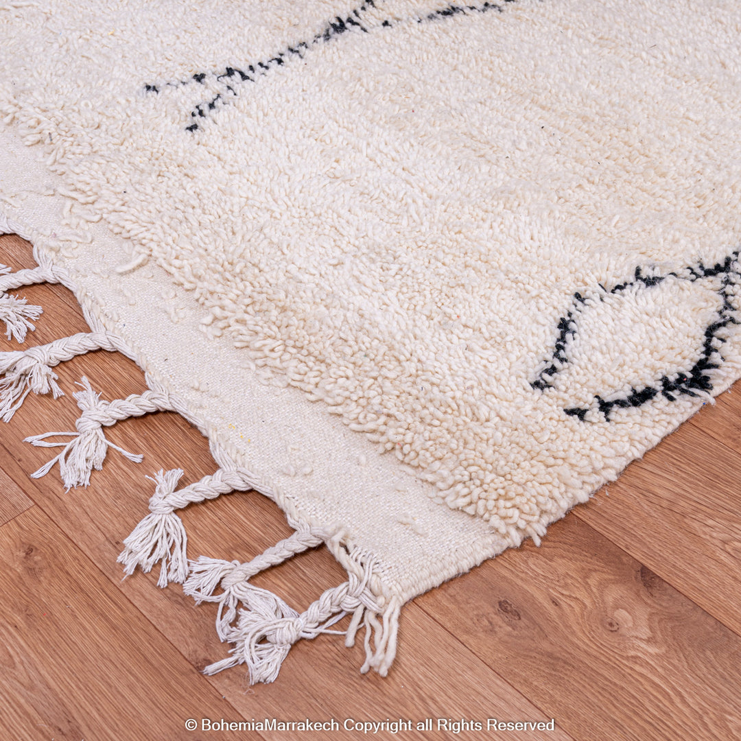Handmade Beni Ourain Moroccan rug with black diamond pattern on ivory wool
