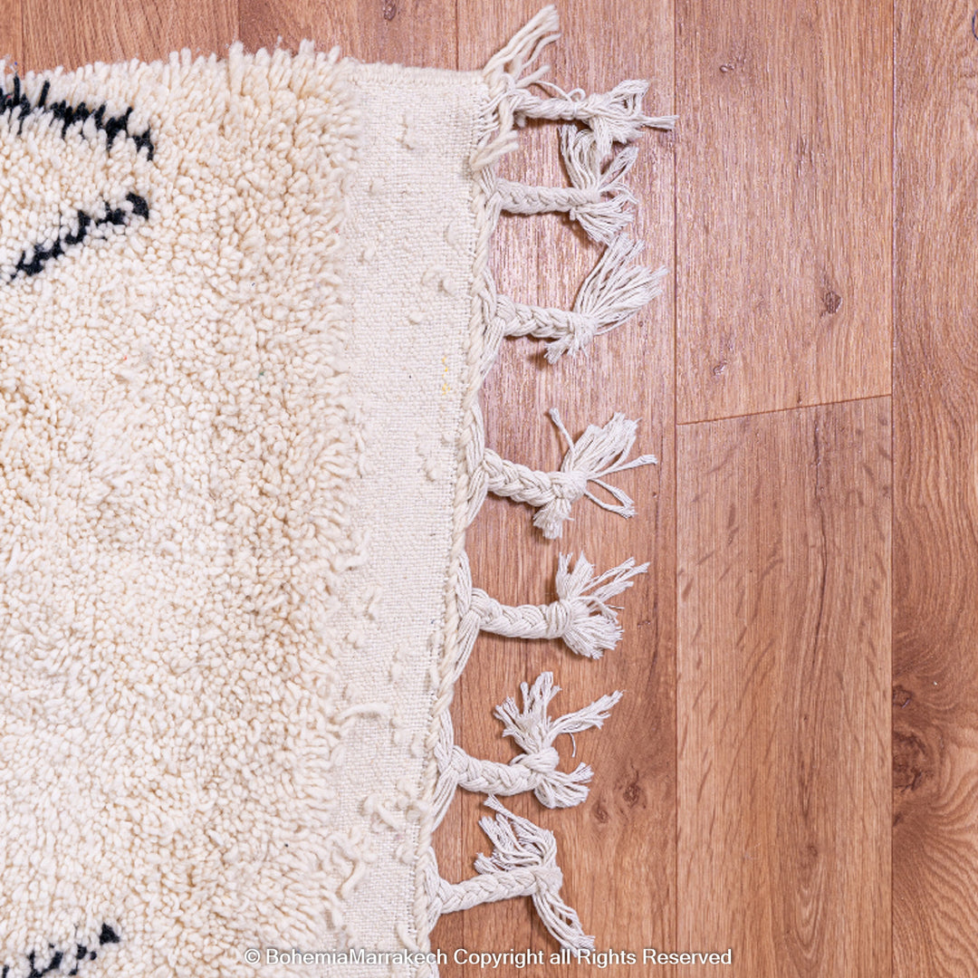 Handmade Beni Ourain Moroccan rug with black diamond pattern on ivory wool