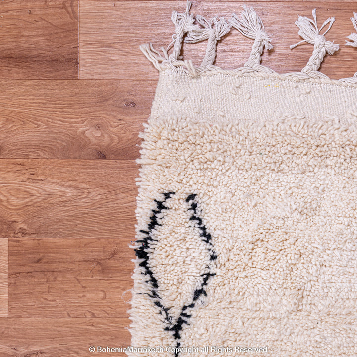 Handmade Beni Ourain Moroccan rug with black diamond pattern on ivory wool