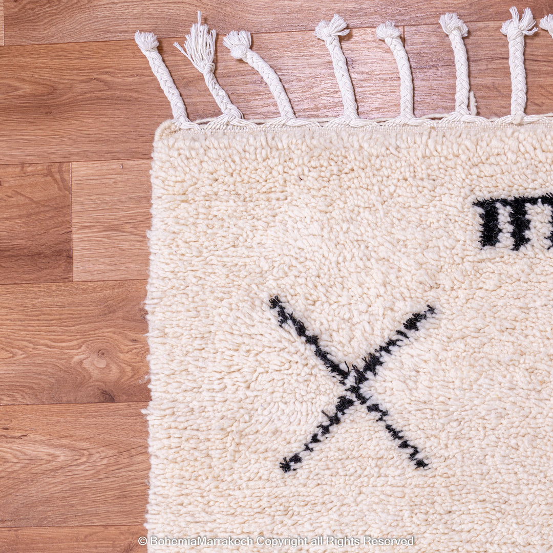 Hand-knotted Beni Ourain Moroccan rug with black tribal diamond patterns on white wool background