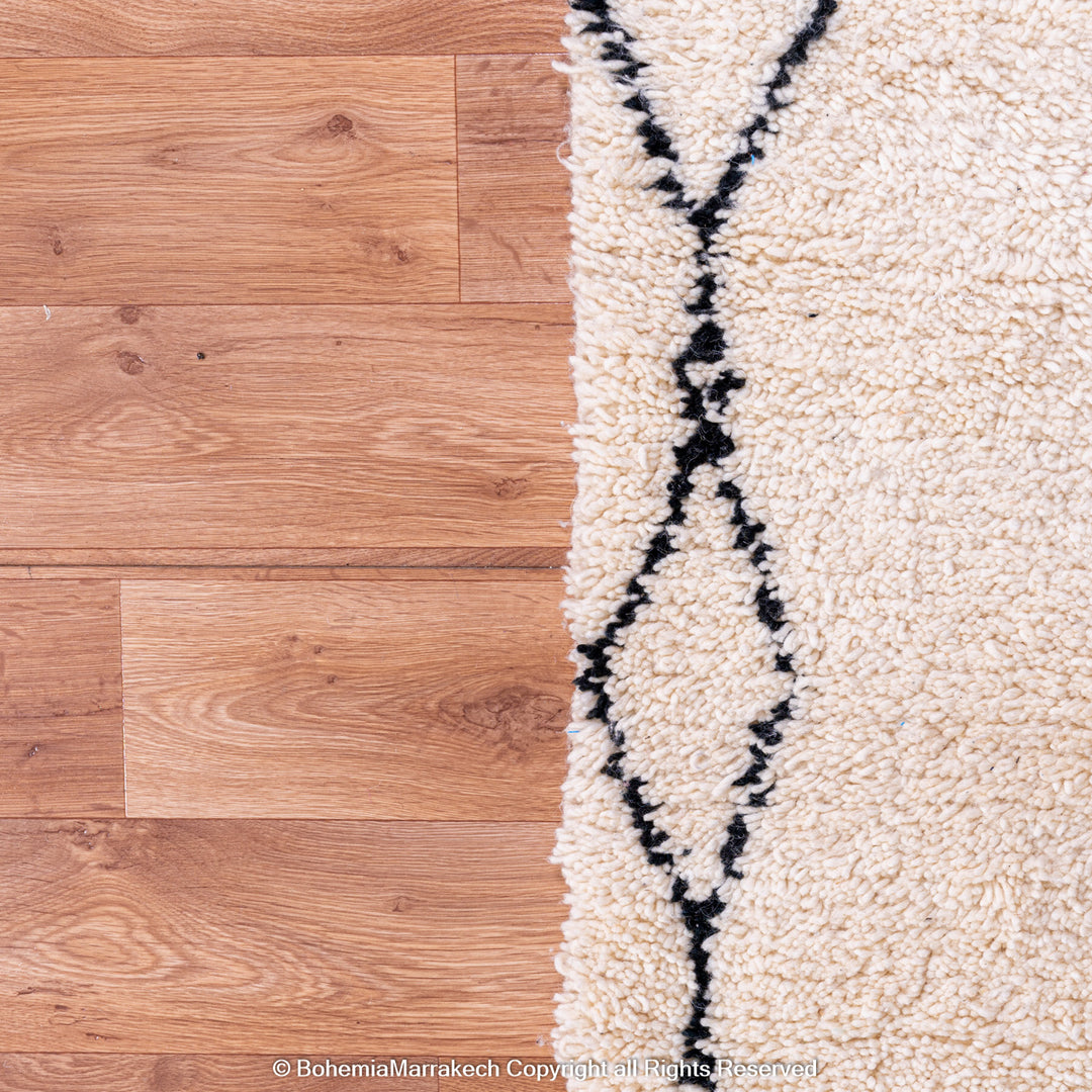 Handmade Beni Ourain Moroccan rug with black diamond pattern on ivory wool