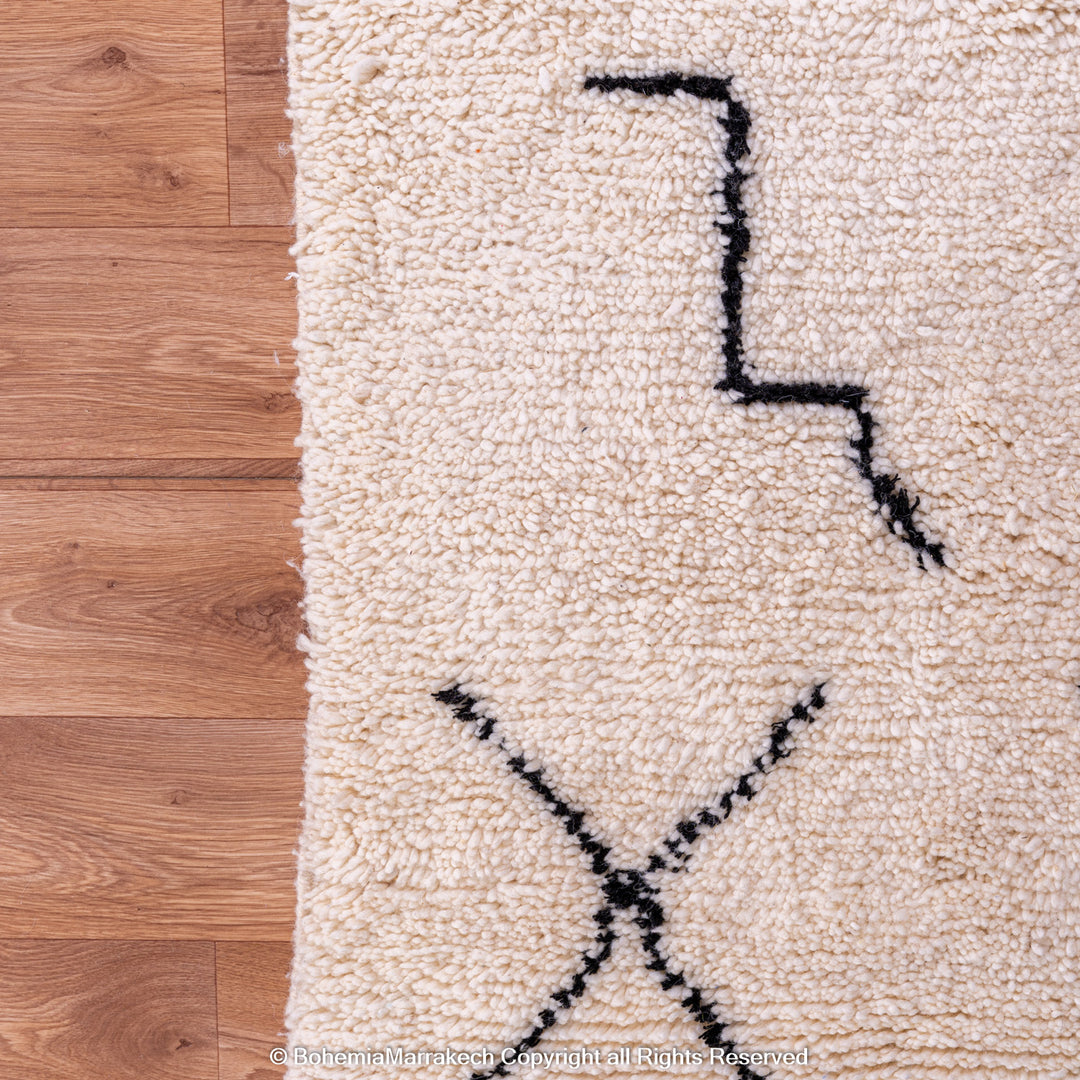 Hand-knotted Beni Ourain Moroccan rug with black tribal diamond patterns on white wool background