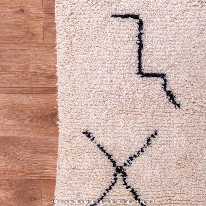 Hand-knotted Beni Ourain Moroccan rug with black tribal diamond patterns on white wool background