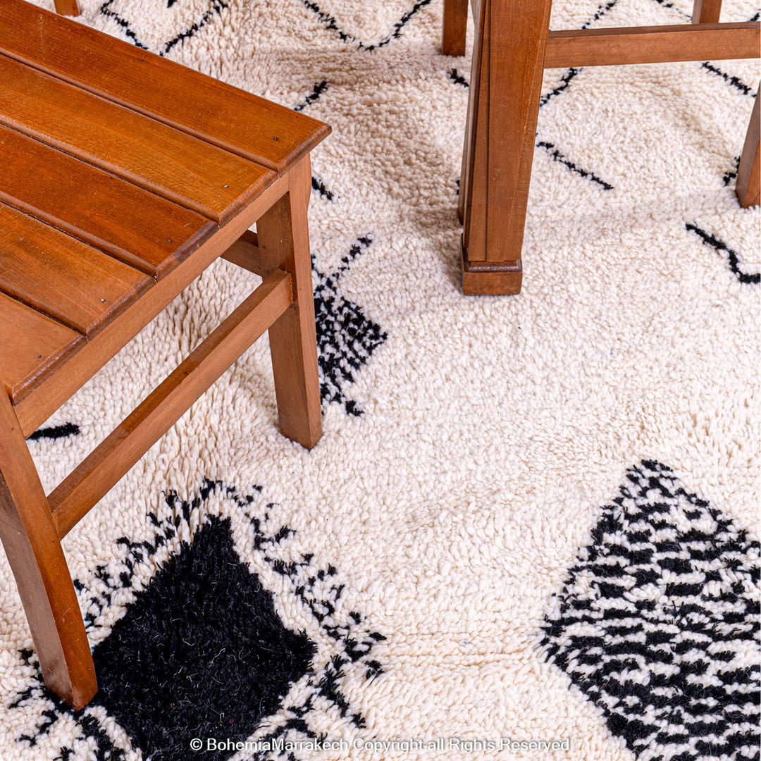 Hand-knotted Beni Ourain Moroccan rug with black tribal diamond patterns on white wool background