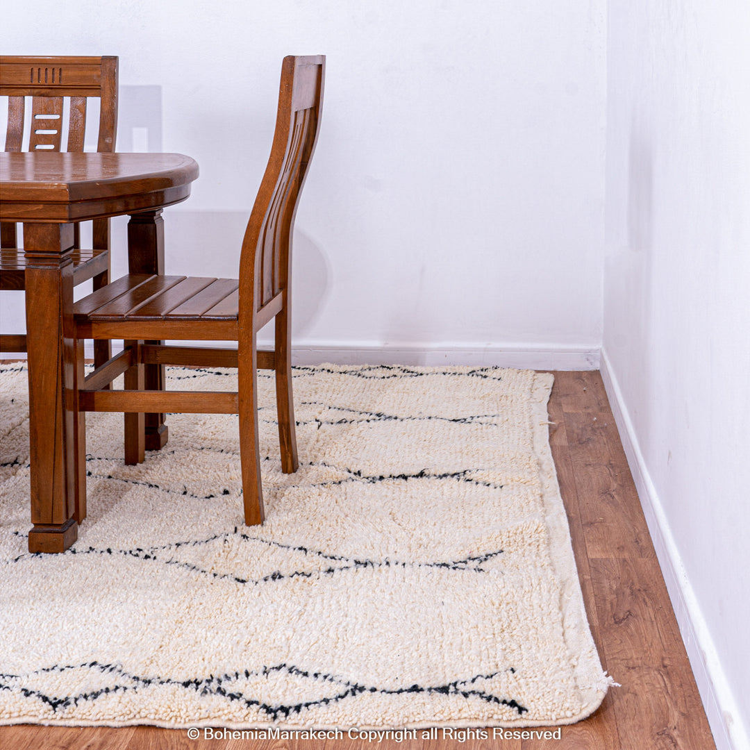 Handmade Beni Ourain Moroccan rug with black diamond pattern on ivory wool