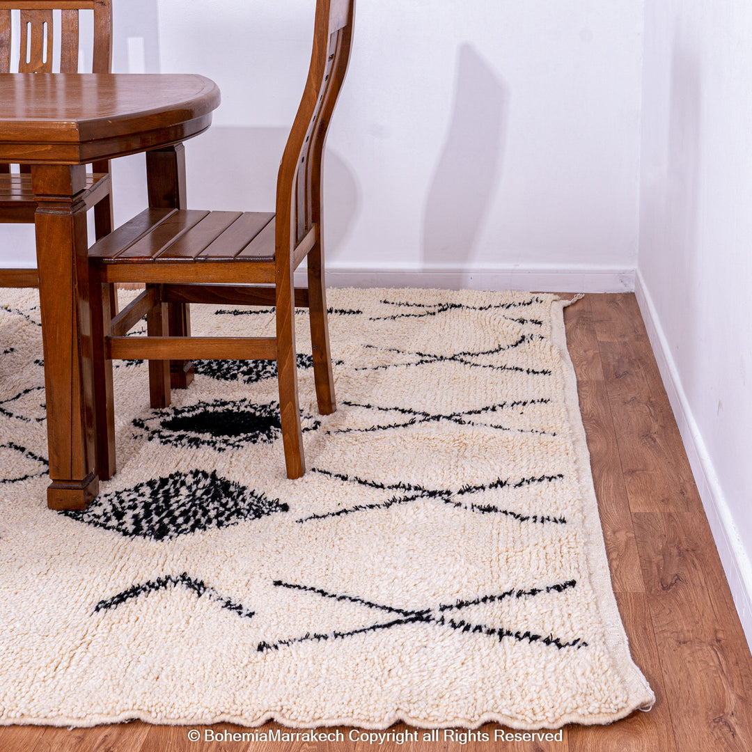 Hand-knotted Beni Ourain Moroccan rug with black tribal diamond patterns on white wool background