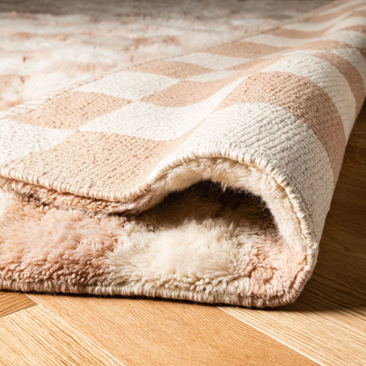 Neutral Checkerboard Beni Mrirt Rug with Moroccan wool, showing beige checkerboard pattern and soft texture on wooden floor.