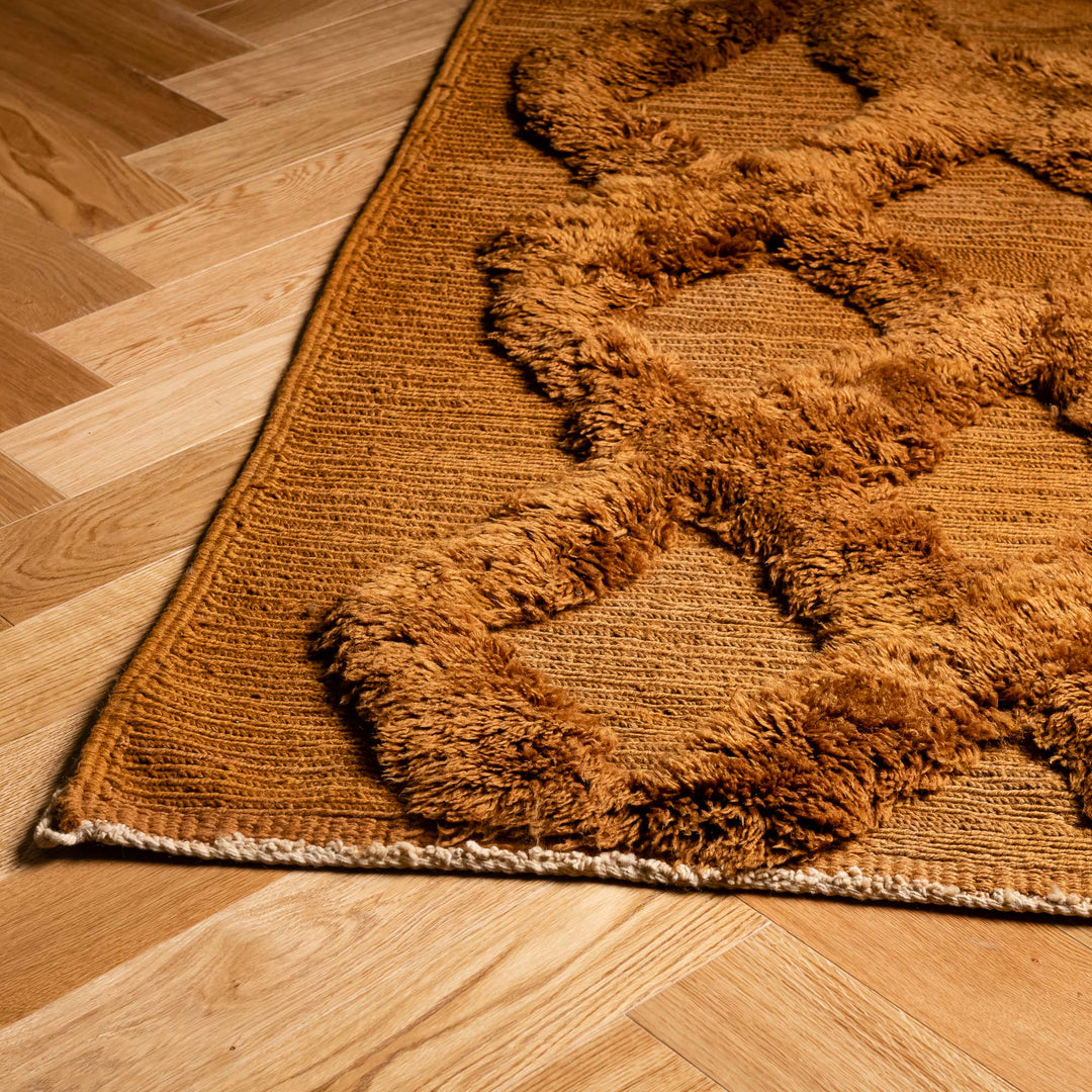 Rust Brown Moroccan Beni Mrirt wool rug with diamond design on a wooden floor, showcasing traditional Moroccan craftsmanship.