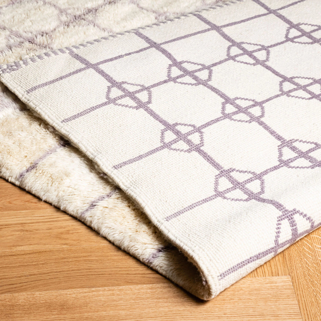 Soft Beni Ourain Moroccan rug with lavender diamond circles, perfect for boho interiors and cozy living rooms.