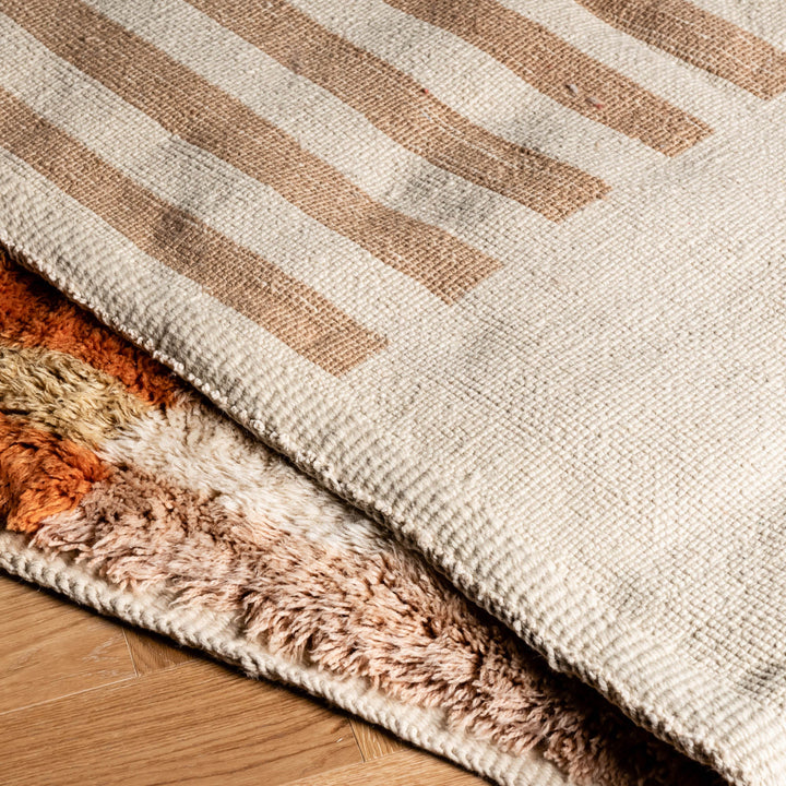 Striped Beni Mrirt rug, Moroccan design with earthy tones, showcasing premium wool and Berber craft, ideal for modern interiors.