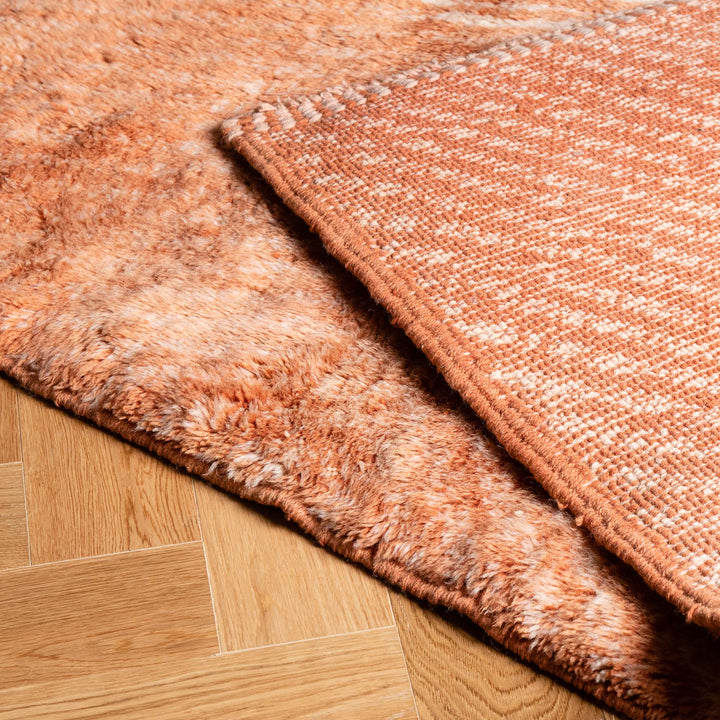 Terracotta Chevron Moroccan Wool Rug with a plush Berber texture and hand-carved pattern, ideal for cozy spaces.