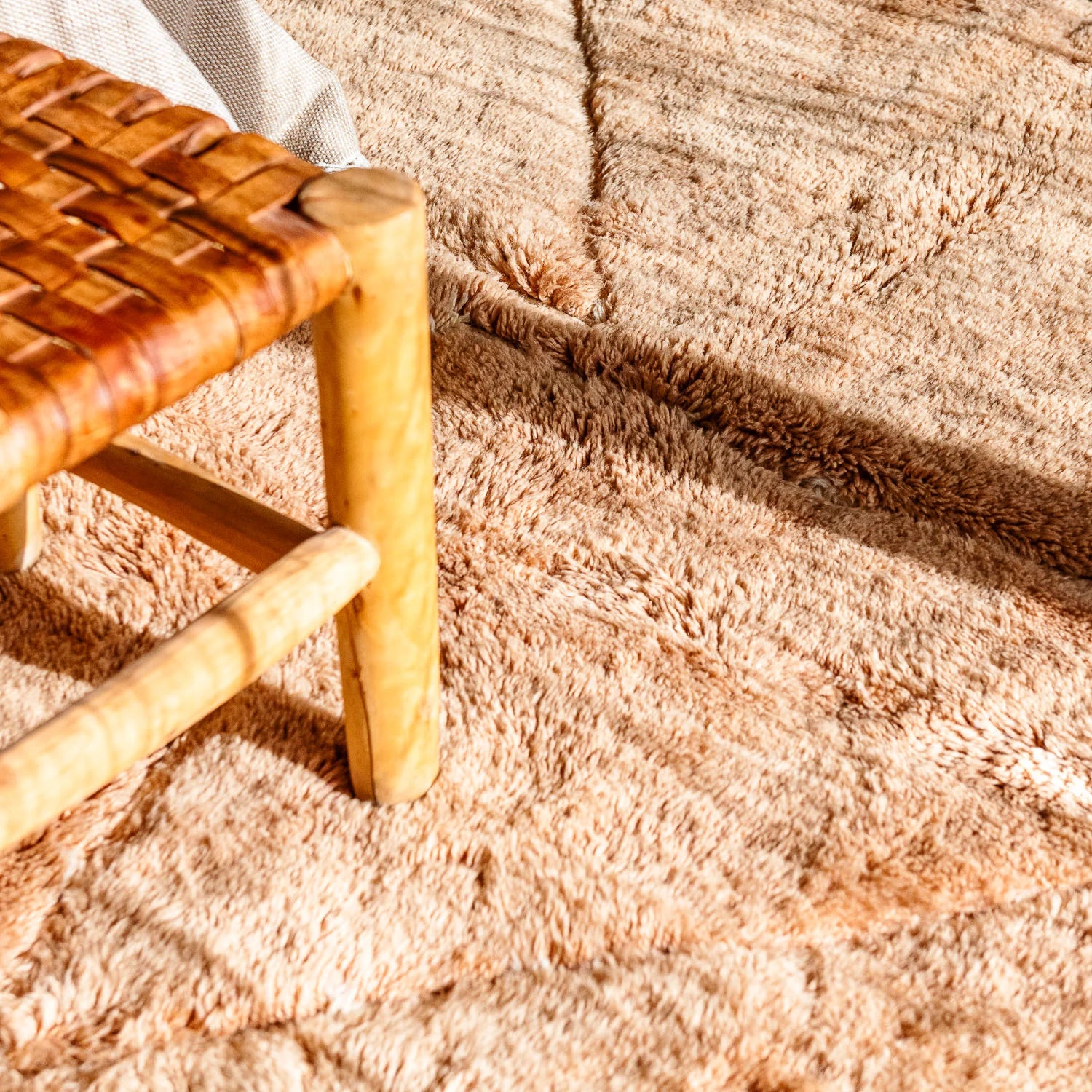 Handwoven Moroccan Beni Ourain rug in natural wool with traditional Berber symbols