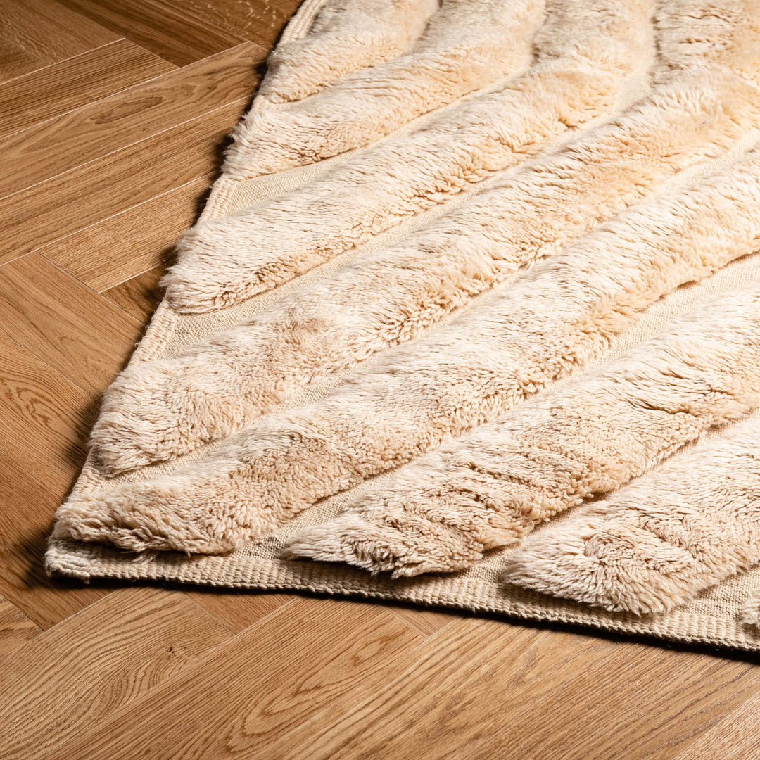 Handmade beige Moroccan wool rug with textured chevron pattern, perfect for modern and bohemian interiors.