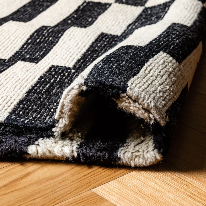 Black and white checkered Moroccan wool rug showcasing traditional Berber patterns, handcrafted for timeless elegance.