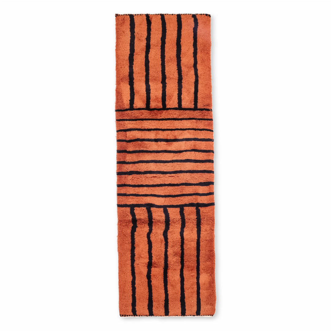 Handwoven Moroccan runner rug with black stripes, made from 100% natural wool, showcasing traditional Berber patterns.