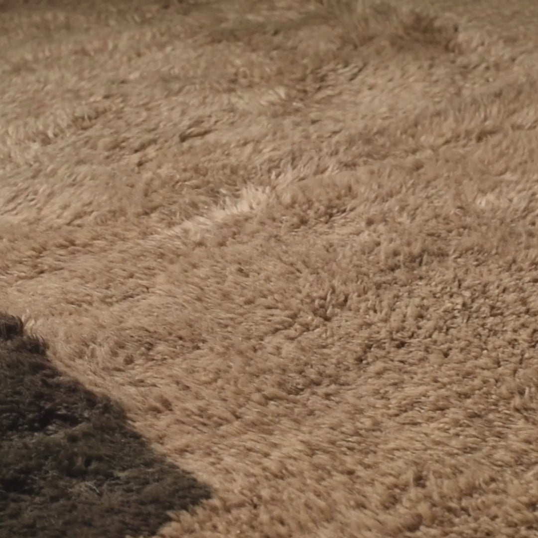 Close-up of a handmade Moroccan wool rug in neutral tones, showcasing soft texture ideal for minimalist interiors.