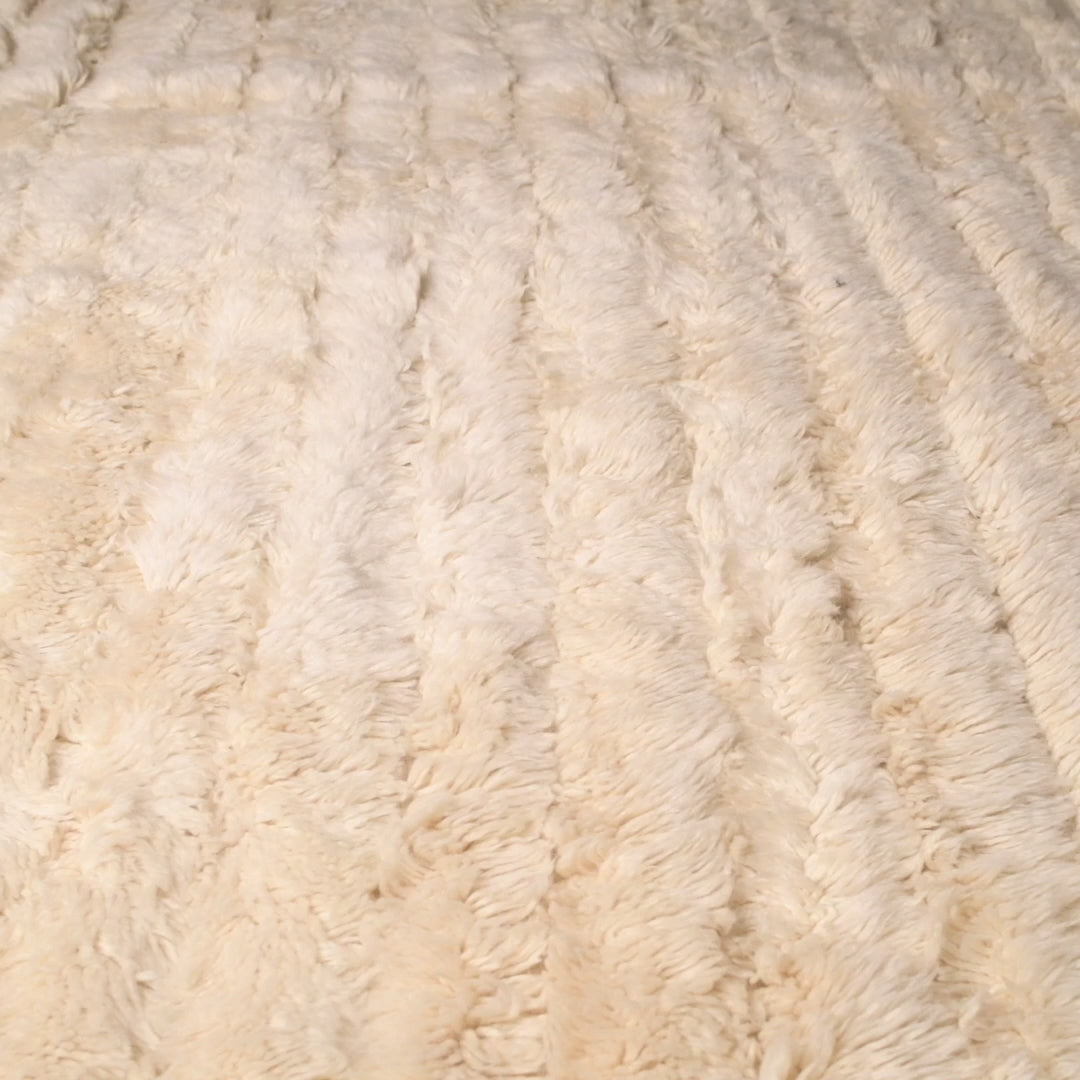 Cream textured Beni Mrirt Moroccan wool rug with ribbed design, showcasing traditional craftsmanship. Ideal for modern interiors.