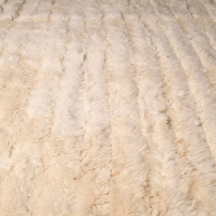 Cream textured Beni Mrirt Moroccan wool rug with ribbed design, showcasing traditional craftsmanship. Ideal for modern interiors.