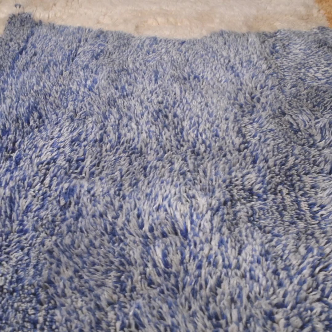 Blue and cream Moroccan wool rug with a textured, plush surface.