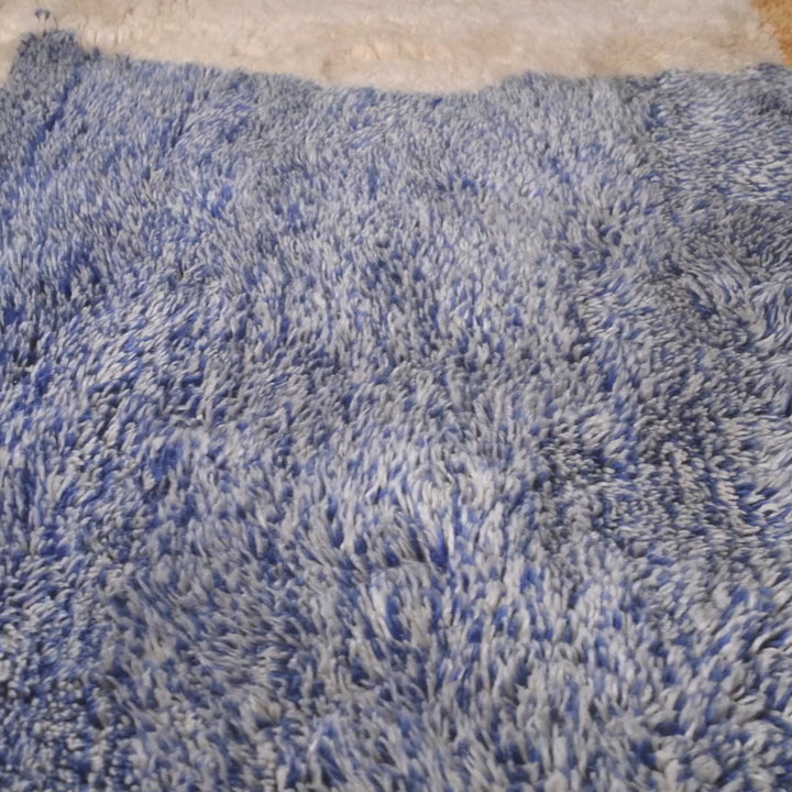 Blue and cream Moroccan wool rug with a textured, plush surface.