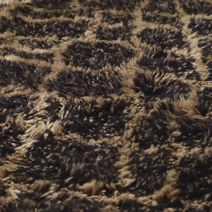 Close-up of handmade Beni Mrirt Moroccan rug with black diamond pattern, showcasing its plush wool texture and traditional Amazigh design.