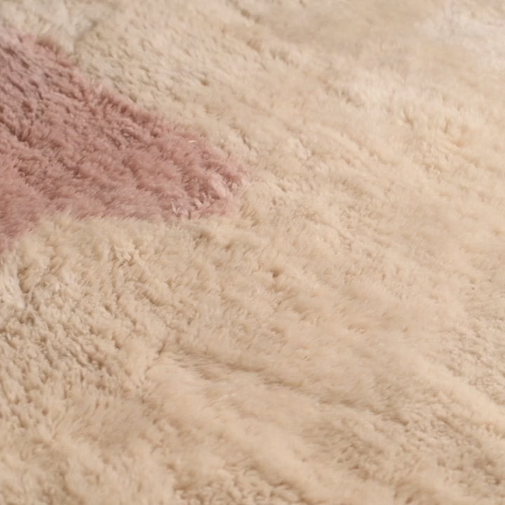 Close-up of Modern Pink Abstract Beni Mrirt Moroccan wool rug with soft ivory and rose-pink design, ideal for minimalist decor.