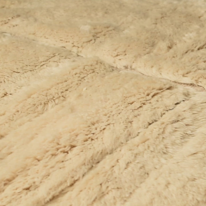 Close-up of Minimalist Cream Beni Mrirt Rug showing plush Moroccan wool texture and organic patterning.