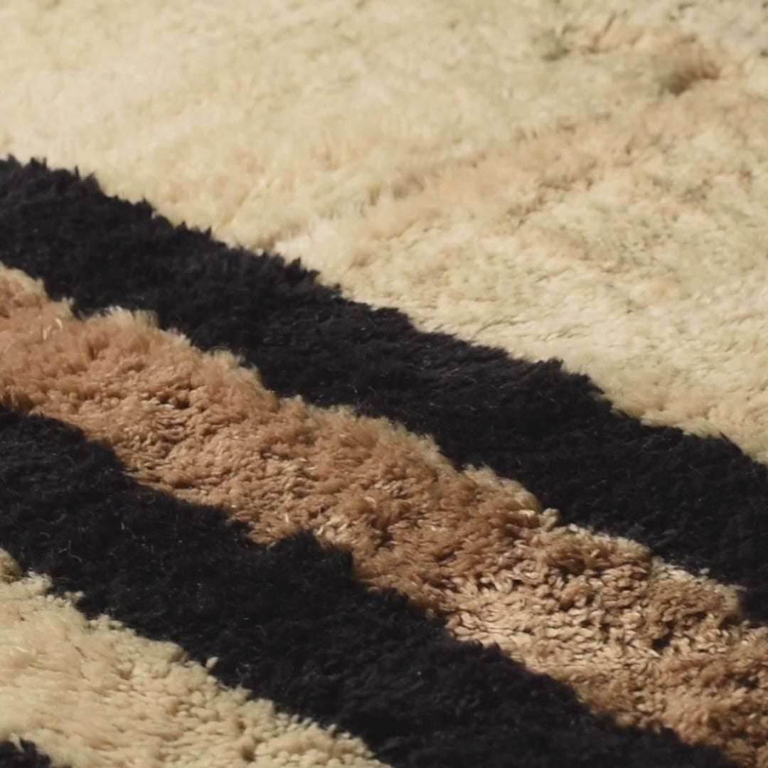 Close-up of Custom Beni Mrirt Rug with geometric black and brown borders, handmade Moroccan wool rug.