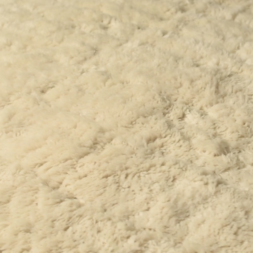 Close-up of a plush creamy beige Beni Mrirt rug, showcasing thick pile and texture, handmade Moroccan wool carpet.