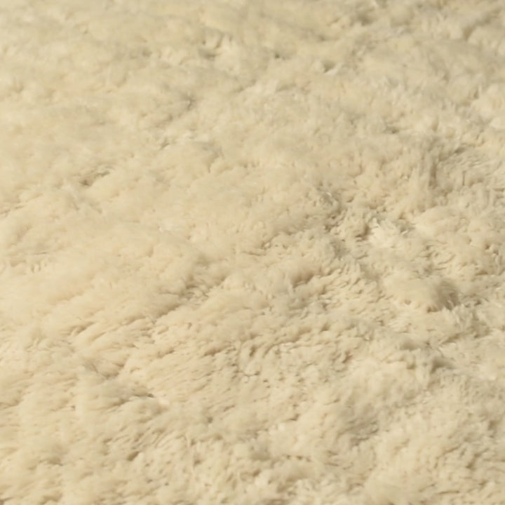 Close-up of a plush creamy beige Beni Mrirt rug, showcasing thick pile and texture, handmade Moroccan wool carpet.