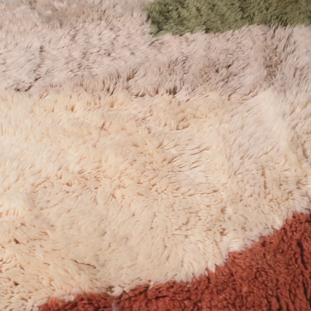 Modern abstract Moroccan wool rug in terracotta, beige, and olive green, handmade and plush, perfect for creative home decor.