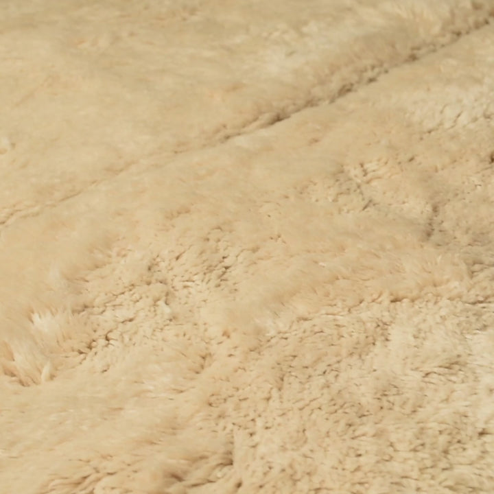 Neutral Beni Mrirt Moroccan wool rug with hand-carved triangle motifs, ideal for calm and minimalist interiors. Creamy ivory pile.