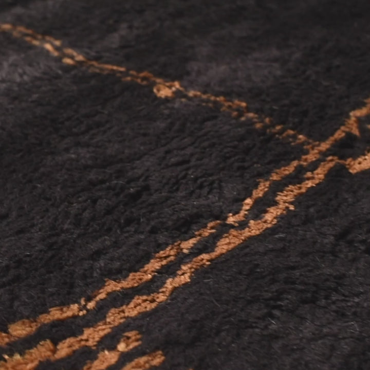 Dark charcoal Moroccan wool rug with golden abstract patterns, handmade and richly textured. Ideal for adding warmth and style.