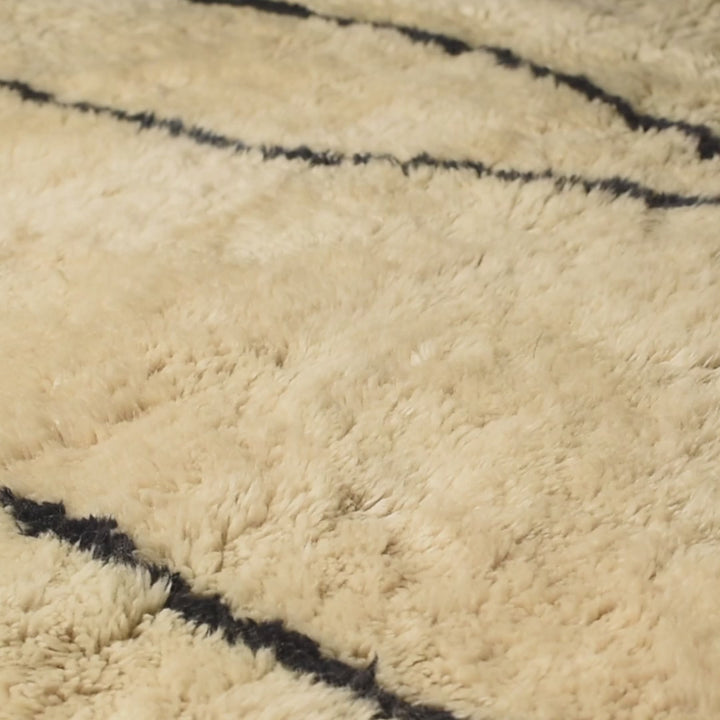 Handcrafted Beni Mrirt wool rug with abstract linear motifs, showcasing traditional Moroccan Berber artistry and luxury texture.