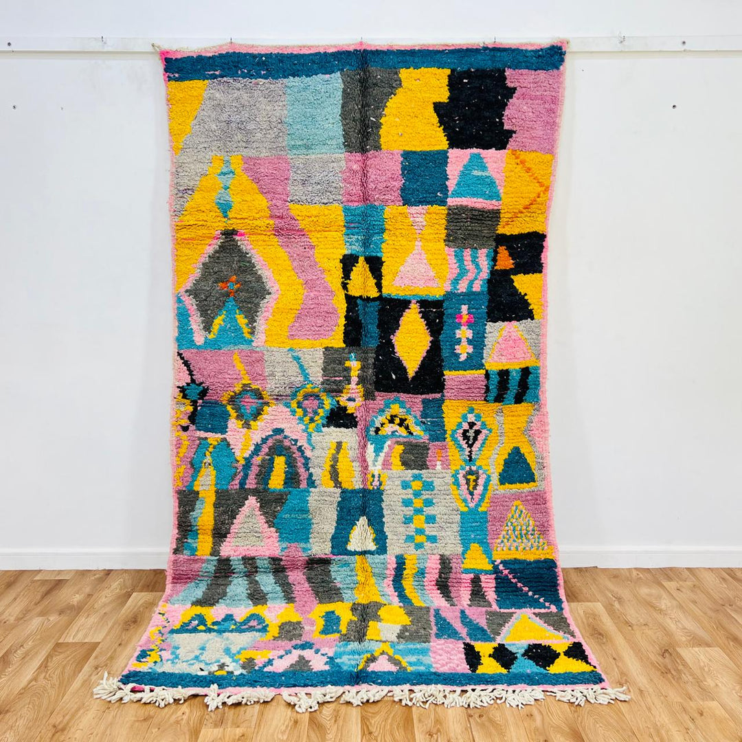 Vintage Moroccan wool rug 620 – handmade colorful geometric pattern with pink, yellow, and blue tones, 255 × 144 cm (8.36 × 4.72 ft).