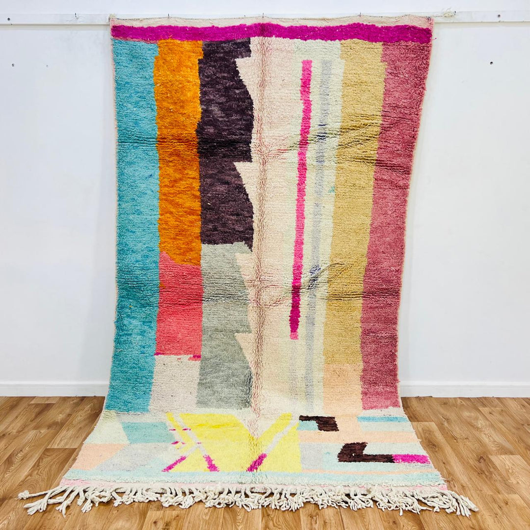 Vintage Moroccan wool rug 710 – handmade colorful vertical stripe abstract pattern in pink, turquoise, and yellow tones, 270 × 153 cm (8.86 × 5.02 ft).
