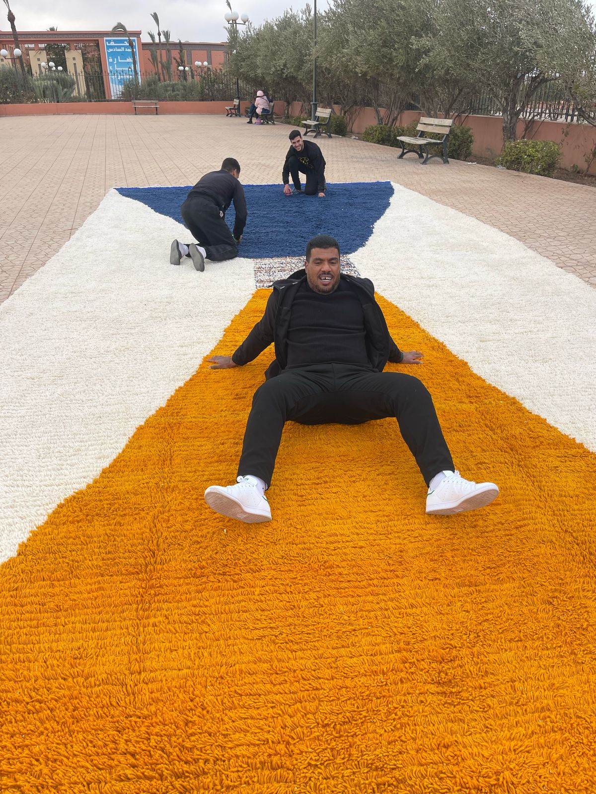 Abdelilah Benhadda relaxing on custom Beni Ourain rug