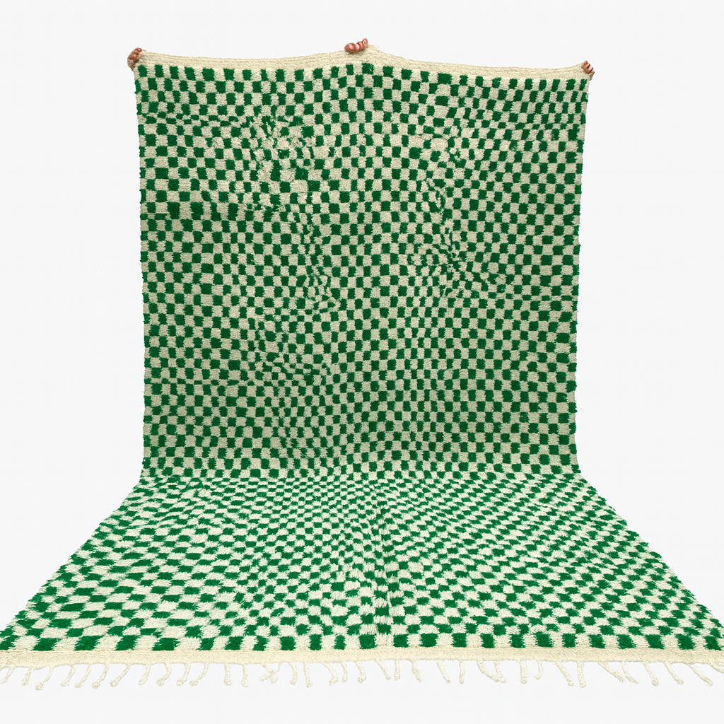 Green and white checkered rug with tassels on a white background