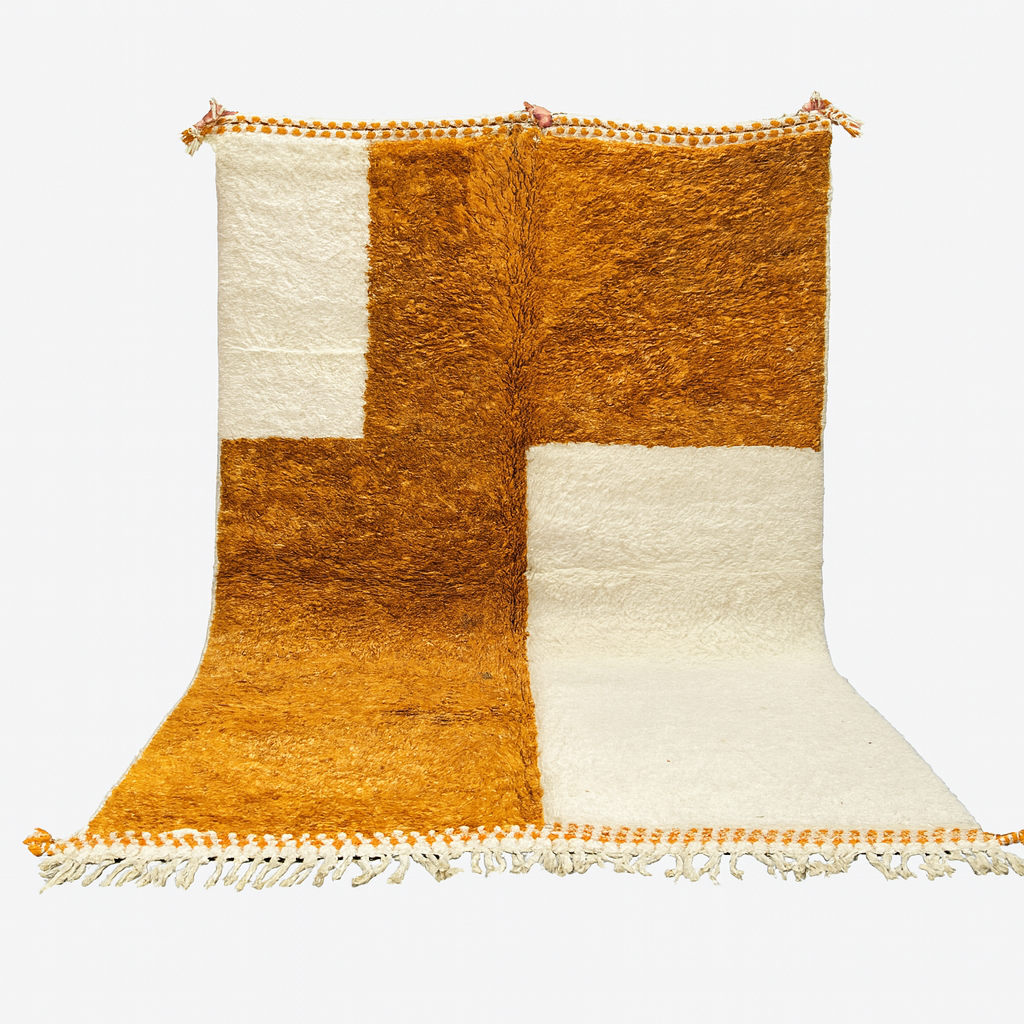 Woven rug with orange and white pattern on a white background