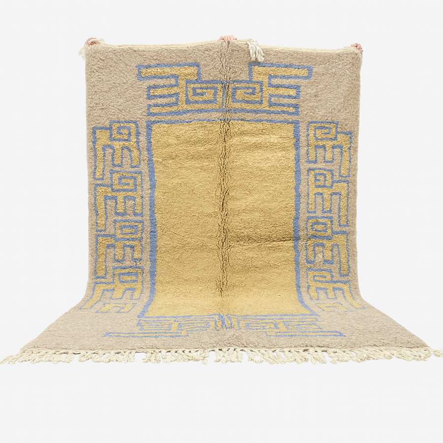Beige rug with blue geometric patterns on a white background