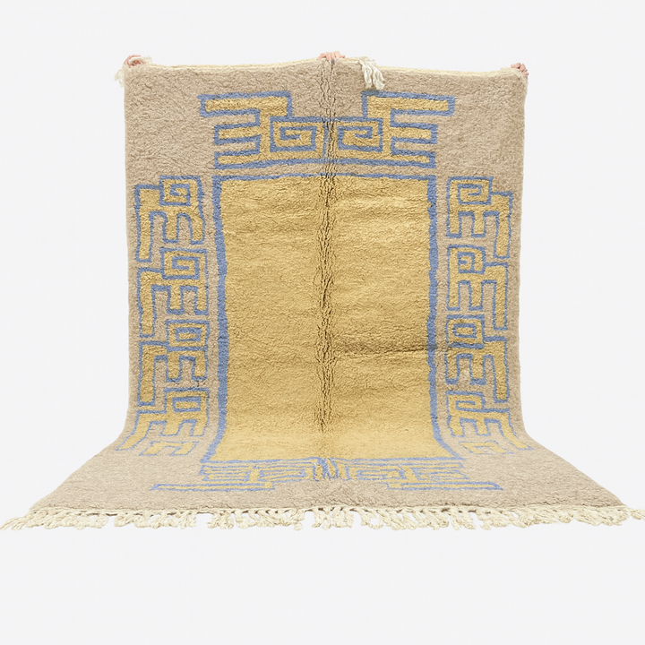 Beige rug with blue geometric patterns on a white background